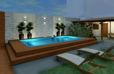 an outdoor swimming pool with lounge chairs and potted plants next to it at night