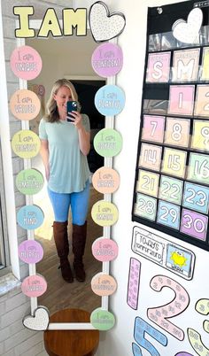 a woman taking a selfie in front of a mirror with numbers and hearts on it