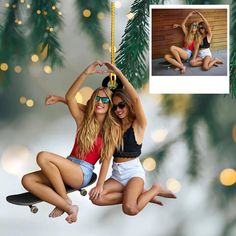 two beautiful young women riding on top of a skateboard in front of a christmas tree