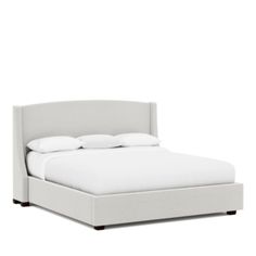 a bed with white sheets and pillows on it's headboard, against a white background