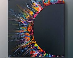 an abstract painting on a wall with a circular hole in the center and colorful paint splatters all over it