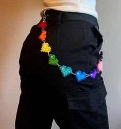 a person wearing black pants with colorful beads on them