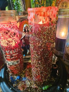 two jars filled with candy sitting on top of a table