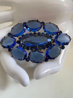 "Vintage Stunning Clear Blue Oval Rhinestone Brooch. This sparkling pin is the perfect accessory to adorn your sweater, coat, or scarf, adding a touch of elegance and flair to any outfit. Approx Measurements 3\" Long 1.75\" Wide Condition: Vintage Excellent.   Sold as is.   PLEASE review all pictures closely.  Contact me with any questions or problems with your order. Thank you for shopping in my store.  International buyers please contact me for shipping details and cost. Most of my items are vintage and used, they will all show some signs of light wear or use.   Major flaws will be noted in the description.  Items are sold \"as is\" so please make sure you look at all pictures carefully.  I have done my best to capture color and size.  I am not an expert on vintage items but I do my best Elegant Blue Oval Brooches, Elegant Oval Blue Brooches, Blue Oval Brooch For Formal Occasions, Czech Jewelry, Jewelry Boards, Sweater Coat, Rhinestone Brooches, Vintage Costume Jewelry, Vintage Costumes