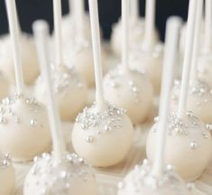 cake pops with white frosting and sparkles on them are ready to be eaten