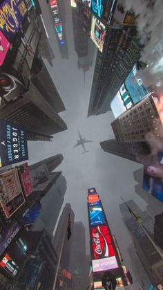 an aerial view of a city with skyscrapers and billboards in new york's times square