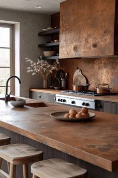 a kitchen with an island counter and wooden stools