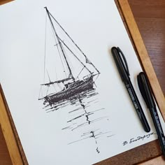 a pen and ink drawing of a sailboat in the water on a piece of paper