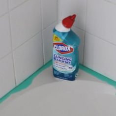 a bottle of clorox sitting on top of a toilet