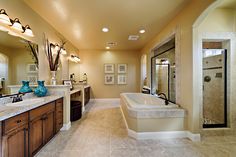 a large bathroom with two sinks and a bathtub next to a walk in shower