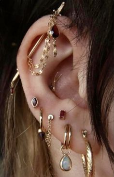 an ear with several different types of piercings on it