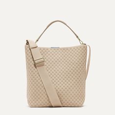 Versatility is the name of the game. With a crossbody strap, detachable top handle and plenty of pockets, our durable bucket bag in a khaki basketweave pattern is a workhorse that can be worn your way. Beige Top Handle Bucket Bag With Intrecciato Weave, Beige Bucket Bag With Intrecciato Weave And Top Handle, Beige Bucket Bag With Intrecciato Weave, Modern Beige Bags With Woven Leather, Modern Beige Woven Leather Bag, Beige Bucket Bag With Intrecciato Weave For Daily Use, Beige Intrecciato Weave Bucket Bag For Everyday, Beige Bucket Bag With Intrecciato Weave For Everyday, Everyday Beige Bucket Bag With Intrecciato Weave