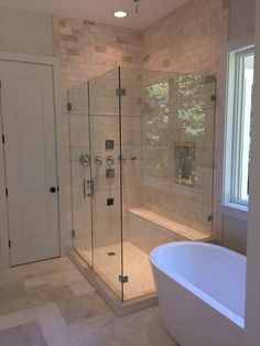 a bathroom with a tub, shower and sink