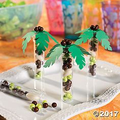 two palm trees made out of candy sticks on a tray