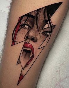 a woman's face with a lightning bolt coming out of her mouth tattoo on the leg