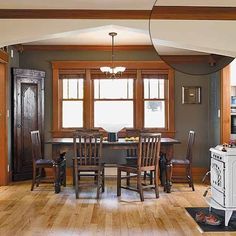 a dining room with wooden floors and gray walls