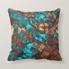 a blue and brown pillow with an abstract design on the front, sitting on a white background