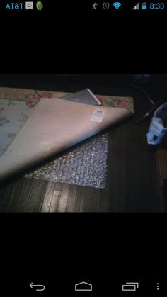 an open laptop computer sitting on top of a wooden table next to a mouse pad