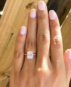 a woman's hand with a diamond ring on it