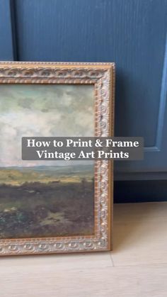 a painting sitting on top of a wooden floor next to a blue door with text overlay that reads how to print & frame vintage art prints