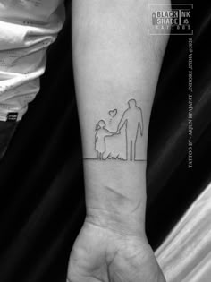 a person with a tattoo on their arm holding a small child's hand and an adult