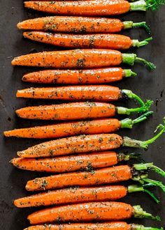 there are many carrots that have been cooked and sprinkled with seasoning