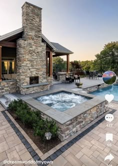 an outdoor hot tub in front of a house with a patio and fire place next to it