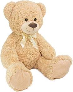 a brown teddy bear sitting on top of a white floor