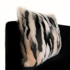 a black and white animal print pillow sitting on top of a chair