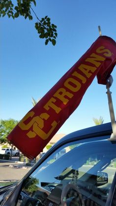 a red and yellow sign that says proproans on top of a car