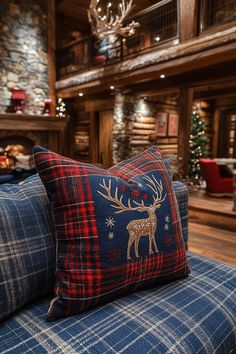 a blue couch with a red and black plaid pillow sitting on it's side