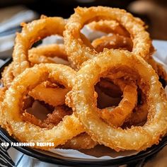 some onion rings are sitting on a plate and ready to be eaten by someone else