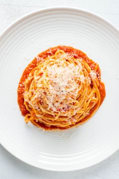 a white plate topped with spaghetti and sauce