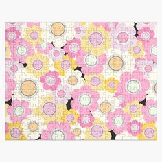 a pink and yellow puzzle with flowers on it