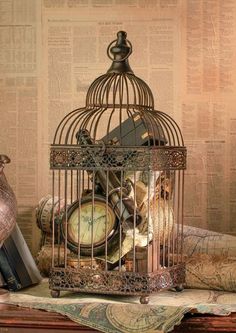 a birdcage filled with lots of junk sitting on top of a table