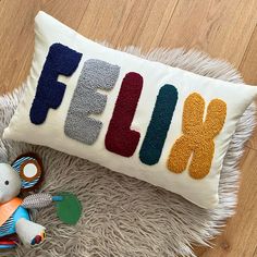 a stuffed animal next to a pillow with the word flunk on it and a teddy bear