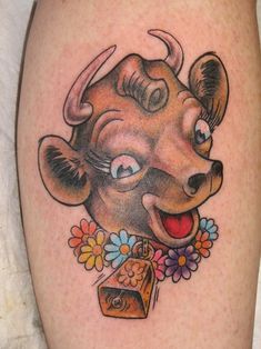 a bull with flowers around it's neck is shown on the leg, and has a tag in its mouth