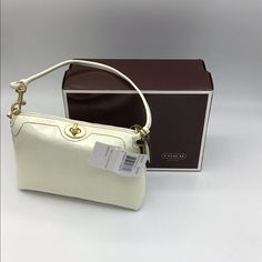 Off White Crinkled Patent Leather Mini Handbag. 7”L X 5”H X 2”W. Removable Strap. Twist Closure. Brass Hardware. Inside Pocket. Can Be Worn As Clutch. Perfect For Carrying Essentials. Excellent Condition. Coach Cream Pouch Shoulder Bag, Coach Clutch Shoulder Bag With Removable Pouch, Coach Clutch Bags For Daily Use, Coach Beige Clutch Bag, Coach Cream Evening Bag, Coach Rectangular Clutch With Detachable Strap, Coach Clutch With Detachable Strap, Rectangular, Cream Box Bag, Coach Cream Shoulder Bag With Top Carry Handle