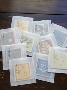 many small squares with designs on them sitting on a table