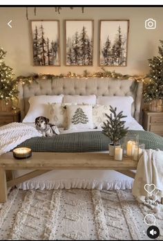 a bedroom decorated for christmas with candles on the bed and pictures hanging above the bed