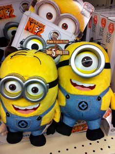 two yellow and blue minion stuffed animals are on display in a store with other toys