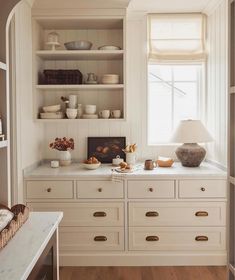 the kitchen is clean and ready to be used for breakfast or dinnertime, with dishes on the shelves