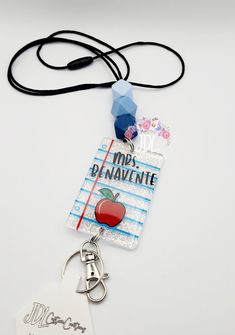 a lanyard with an apple on it and a name tag attached to the lanyard