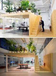 the inside of an office building with plants growing on the wall and stairs leading up to the second floor