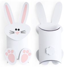 a paper roll holder with an animal's face and paws on it, next to a toilet paper roll holder that is shaped like a bunny