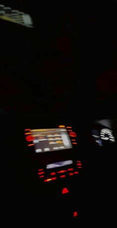 a car dashboard with the lights turned on at night, and there is no image to describe