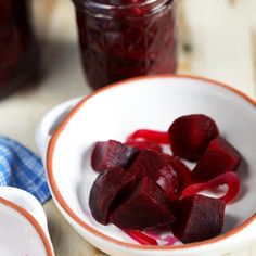 sliced beets in a bowl next to jars of jam