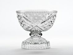 a clear glass bowl sitting on top of a table