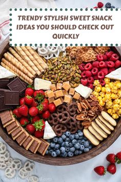 a wooden bowl filled with lots of different types of snacks and desserts on top of it