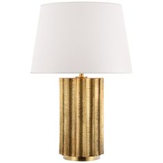 a gold table lamp with a white shade